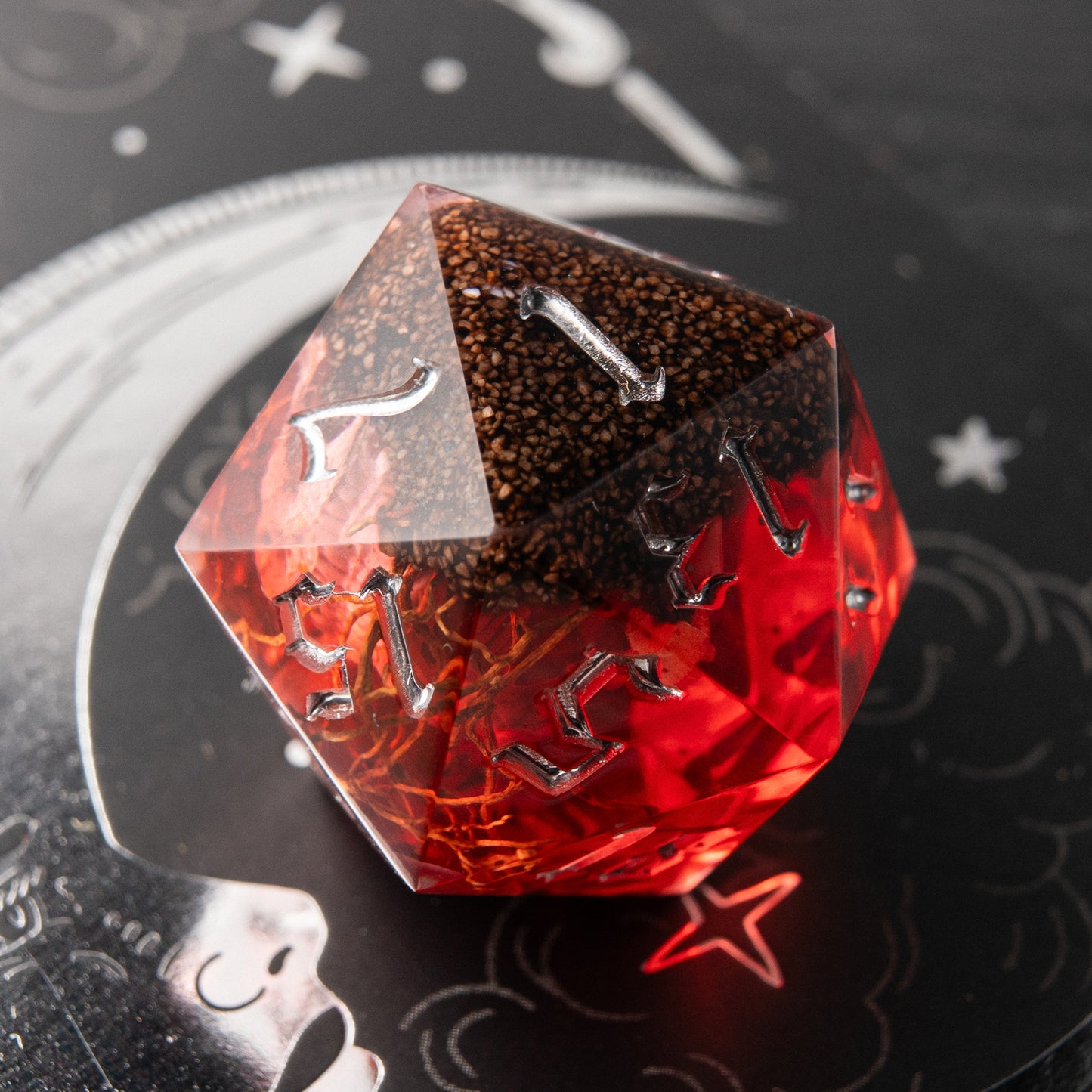 Close-up Blood Omen resin dice – artisan red D20 with bone diorama for tabletop RPG collectors.