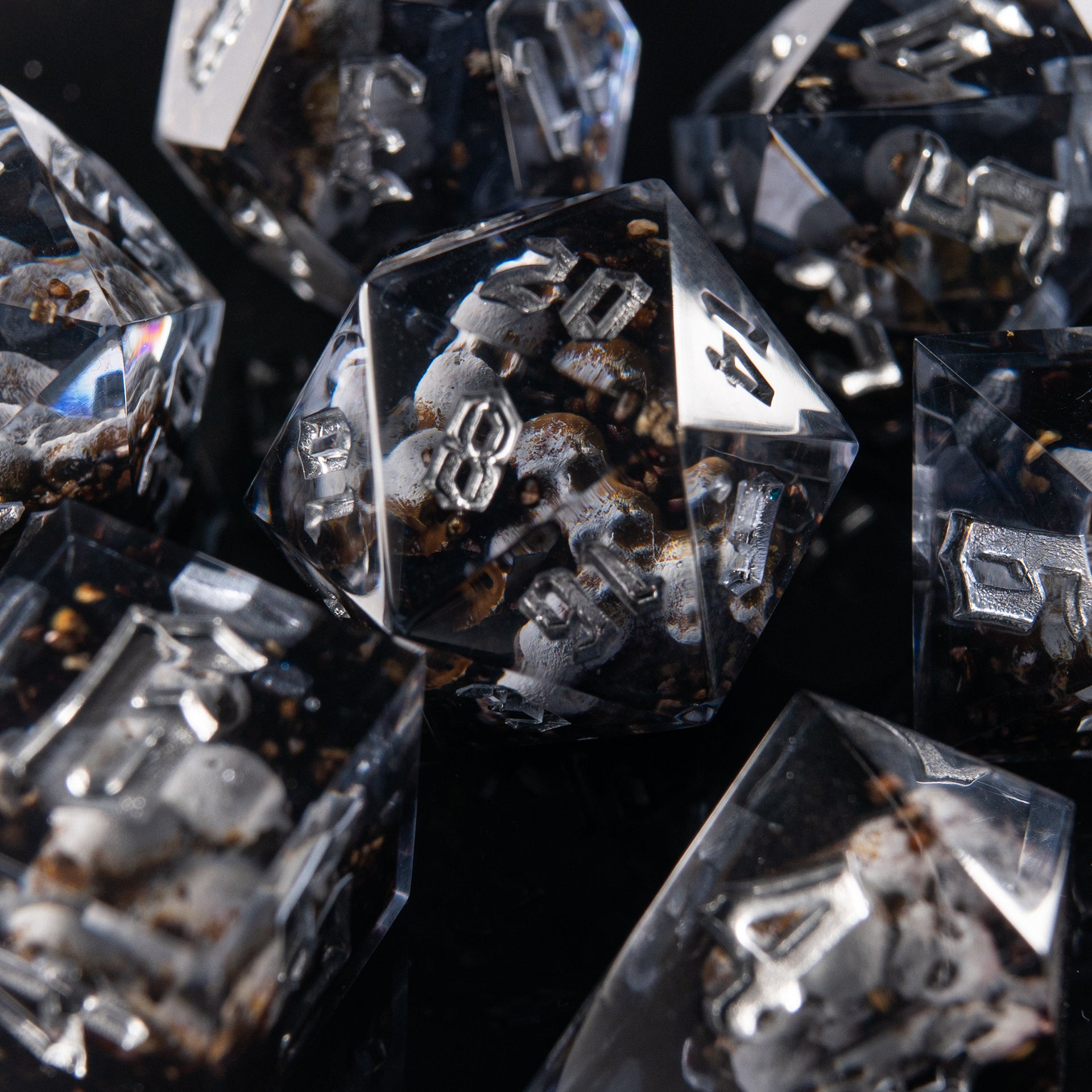 Fantasy resin dice showing souls behind the glass – handmade D&D dice for gothic RPG settings.