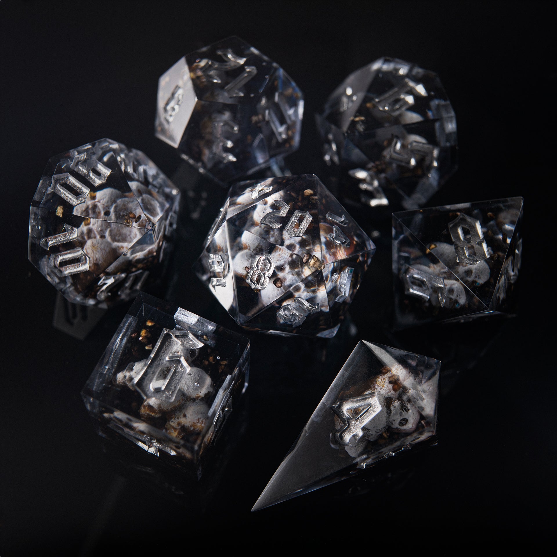 Polyhedral D&D dice featuring ghostly faces inside – artisan resin set for tabletop RPGs.