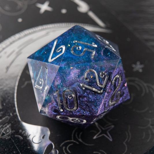 Stellar Veil handmade resin D20 – purple and blue cosmic polyhedral dice for D&D and tabletop RPG.