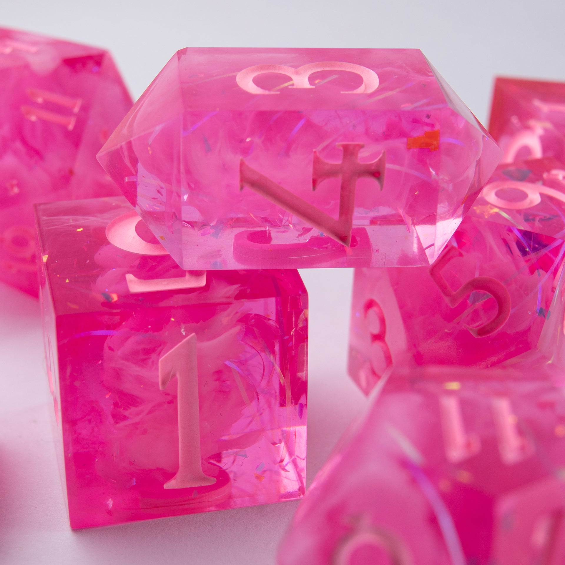 Side view of Eternal Kiss handmade dice – pink resin with shimmering effect