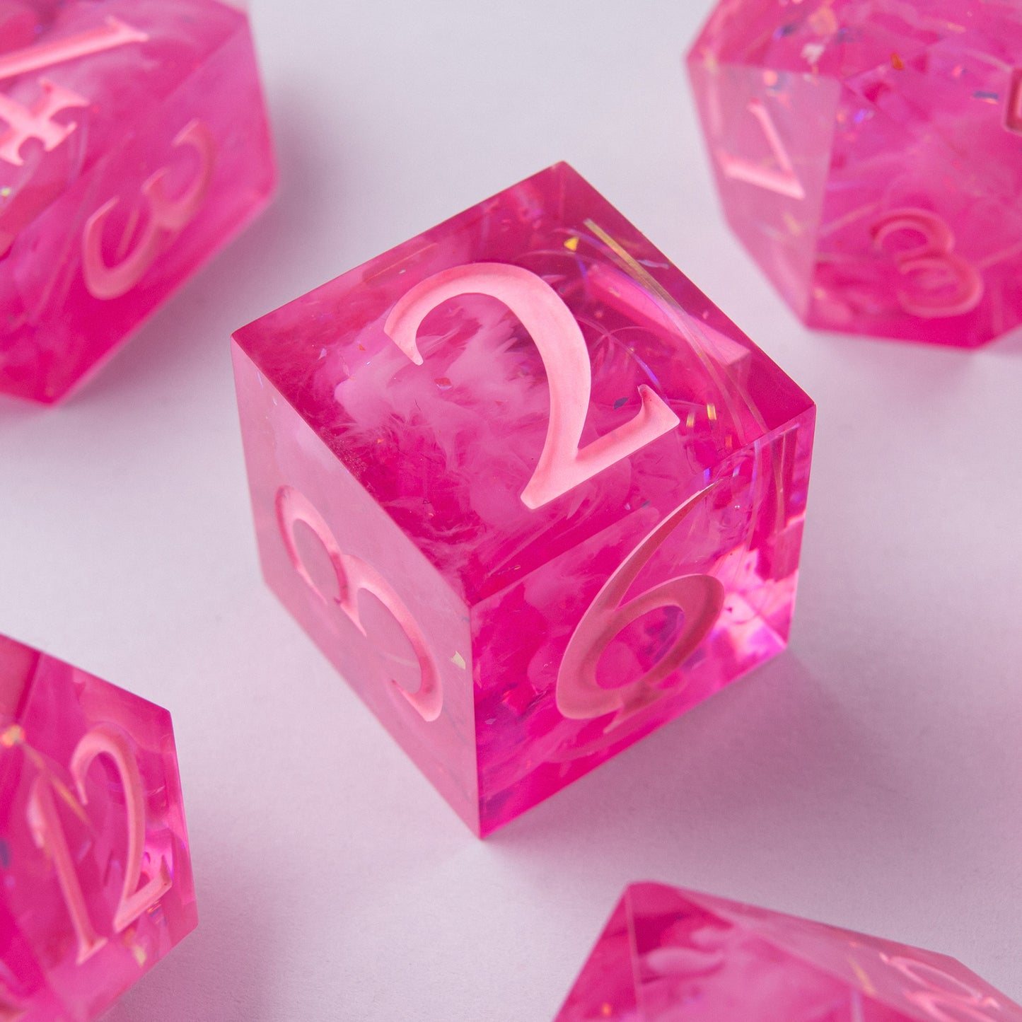 Eternal Kiss dice set stacked – artisan pink resin dice for Dungeons & Dragons.