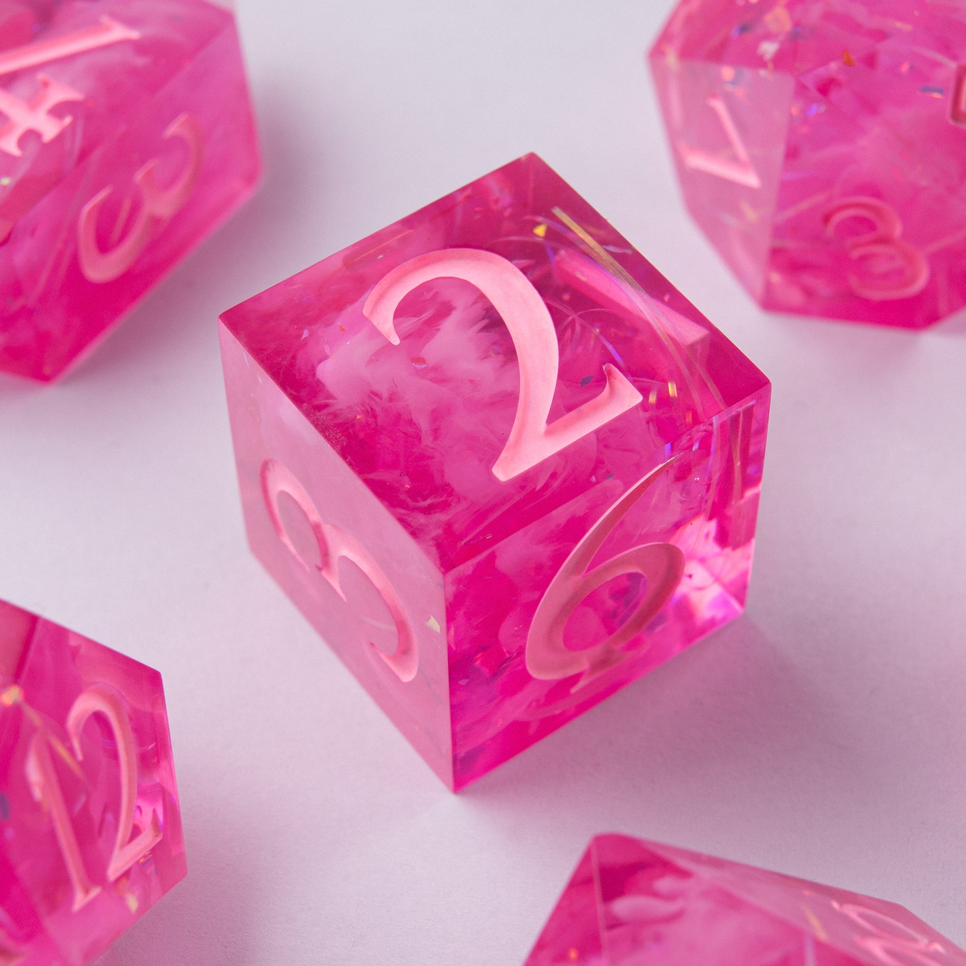 Eternal Kiss dice set stacked – artisan pink resin dice for Dungeons & Dragons.
