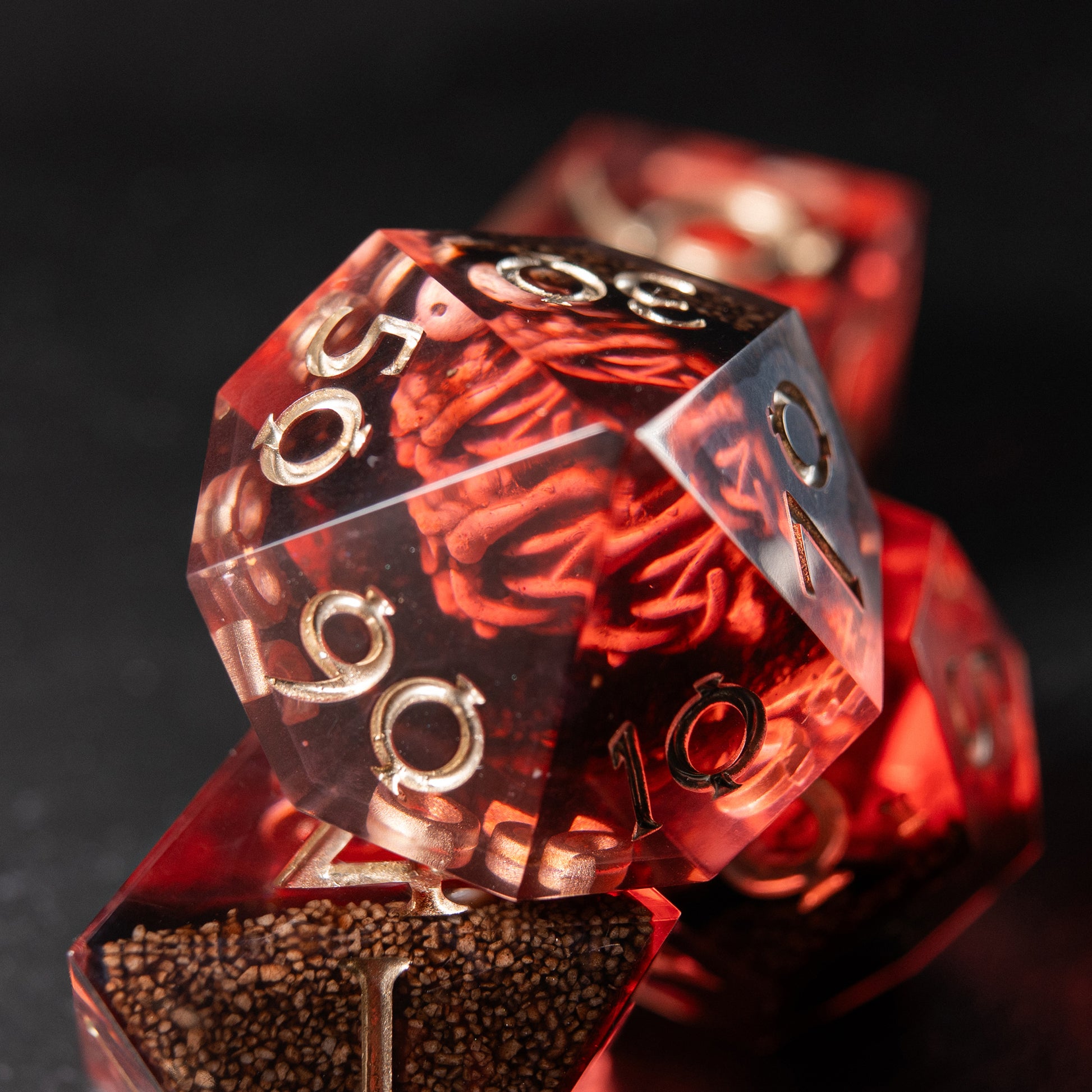 Crimson Reliquary handmade resin dice set – red polyhedral D&D dice with skeletons inside.
