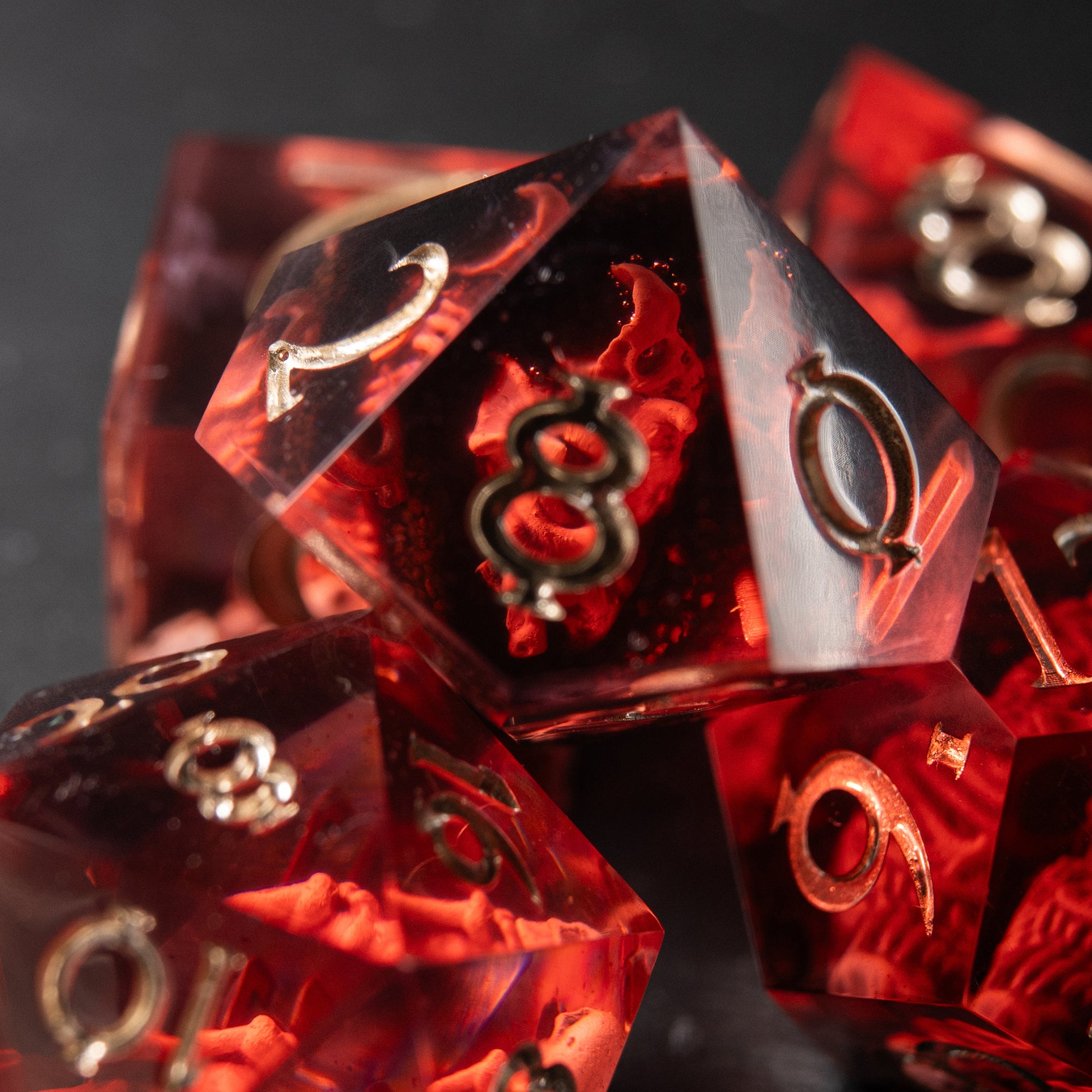 Close-up Crimson Reliquary D20 – handmade resin dice with skeleton motif for Dungeons & Dragons.